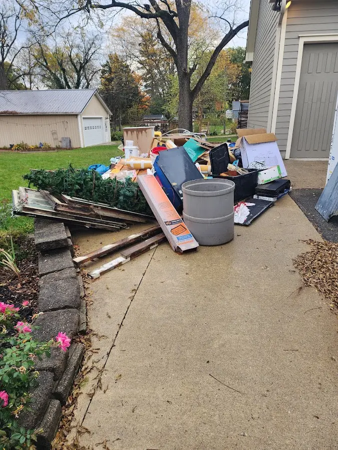 Dumpster being loaded with debris for 3 Yard Dumpster Rental in Innsbrook